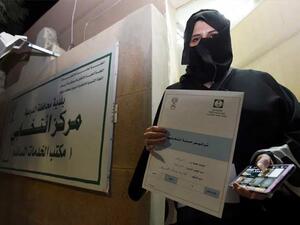 Aljazi al-Hussaini, a candidate for the municipal council in the town of Diriyah, on the outskirts of the Saudi capital Riyadh, shows an electoral campaign licence issued by the central municipal elections committee. (AFP)