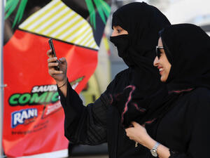 A Saudi woman films using her mobile during the first ever Comic-Con event in the coastal City of Jeddah, on February 16, 2017. (AFP/File)