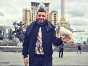 Muhanad laughs as a pigeon stands on his head. (Facebook)