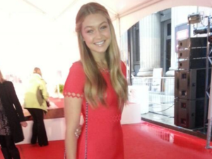 Red really suits Gigi's bronze complexion and blond locks. (Snapshot)
