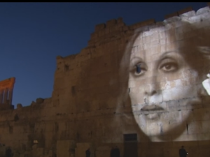 Fairouz's face lit up on the ancient ruins of Baalbeck. (YouTube)