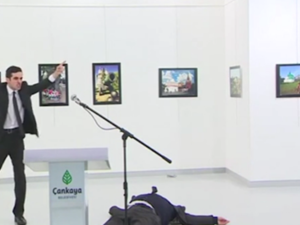 The killer shouted "Allahu Akbar, this is for Aleppo" as he waved his gun around after shooting the ambassador. (Screenshot)