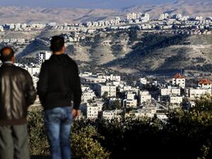 Palestinians look on after major settlement expansion was announced in the days following US President Donald Trump's January 20 inauguration (AFP/THOMAS COEX)