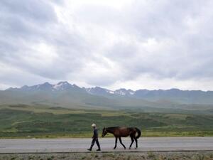 A man walks along a road at a pasture in Kazakhstan situated along the ancient Silk Road. (AFP/File)