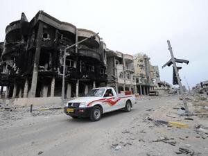 A truck drives through a destroyed neighborhood in Sirte, Libya. (AFP/Philippe Desmazes)
