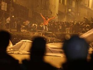 A protester gestures towards riot police after they fired tear gas in front of a barricade in Istanbul on Tuesday, June 4, 2013. (Image credit: Reuters)