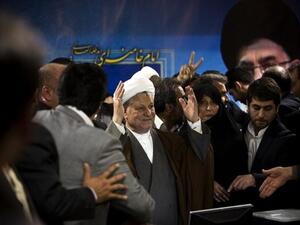 Former Iranian president Akbar Hashemi Rafsanjani (C) arrives with his daughter Fatemeh (C-R) to register his candidacy for the upcoming presidential election at the interior ministry in Tehran on May 11, 2013. (AFP)