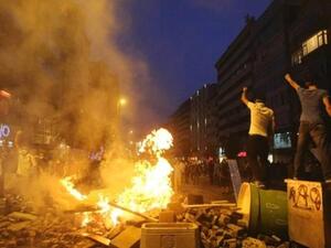 Anti-government protesters shout slogans as they stand on barricades in Istanbul June 16, 2013.