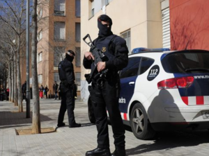 Spanish police outside a suspect's apartment building. (Twitter)