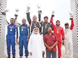 Hamid al Qasimi (second from left) and Khalid al Soomar (right) with their trophies on the podium (Photo: Muscat Daily)