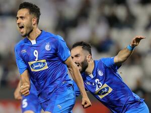 Esteghlal FC's Iranian forward Ali Ghorbani (L) celebrates with his teammates after scoring a goal against Al-Rayyan SC during their Asian Champions League football match at Jassim Bin Hamad Stadium in the Qatari capital Doha on February 13, 2018.
KARIM JAAFAR / AFP