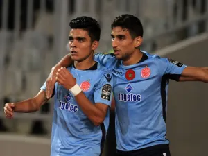 Wydad's striker Achraf Bencharki (L) celebrates his equalising goal with his teammate during the CAF Champions League final football match between Al-Ahly vs Wydad Casablanca at the Borg El Arab Stadium in Alexandria on October 28, 2017.
STRINGER / AFP