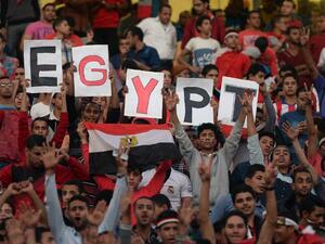 Egyptian fans carry placards and the national flag ahead of the match between Egypt and Senegal during the Africa Cup of Nations group G football match at the Cairo International Stadium in the Egyptian capital on November 15, 2014. AFP PHOTO / KHALED DESOUKI
KHALED DESOUKI / AFP