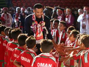 Omani goalkeeper Faiz al-Rushaidi walks among children during a celebration ceremony to welcome Oman's national football team after they won the 23th Gulf Cup of Nations, in Muscat on January 6, 2018.
MOHAMMED MAHJOUB / AFP