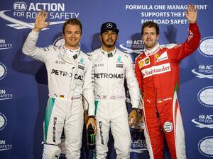 Mercedes AMG Petronas F1 Team's British driver Lewis Hamilton (C) stands next to Mercedes AMG Petronas F1 Team's German driver Nico Rosberg (L) and Ferrari's German driver Sebastian Vettel after securing the pole position in the Bahrain Formula One Grand Prix following the qualifying session at the Sakhir circuit in Manama on April 2, 2016, a day ahead of the race. AFP PHOTO / ANDREJ ISAKOVIC
ANDREJ ISAKOVIC / AFP