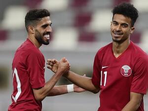 Qatar's forward and captain Hasan al-Haydos (L) celebrates with his teammate Akram Afif after the second goal against Palestine national team during a friendly football match at the Khalifa International Stadium in Doha on September 11, 2018.
KARIM JAAFAR / AFP