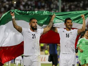 Iran's Ashkan Dejagah (L) Reza Ghoochannejad (R) celebrates among players after winning the 2018 World Cup qualifying football match between Iran and Uzbekistan at the Azadi Stadium in Tehran on June 12, 2017. Iran won 2-0.
ATTA KENARE / AFP