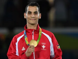 Jordan's Ahmad Abughaush poses with his gold medal on the podium after the men's taekwondo event in the -68kg category as part of the Rio 2016 Olympic Games, on August 18, 2016, at the Carioca Arena 3, in Rio de Janeiro.
Kirill KUDRYAVTSEV / AFP