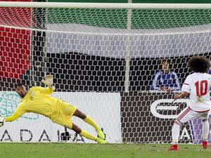 Oman's goalkeeper Fayez al-Rusheidi (L) stops the ball after a penalty by the UAE's player Omar Abdulrahman during the Gulf Cup of Nations 2017 final football match between Oman and the UAE at the Sheikh Jaber al-Ahmad Stadium in Kuwait City on January 5, 2018.
YASSER AL-ZAYYAT / AFP