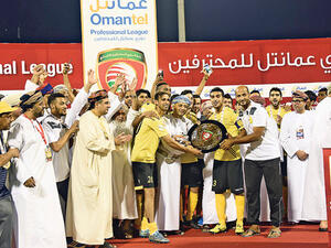 Fanja players receive the OPL shield from Sayyid Khalid al Busaidy, the Oman Football Association chairman, at the Sultan Qaboos Sports Complex on Sunday (Ahmed al Saidi/Muscat Daily)