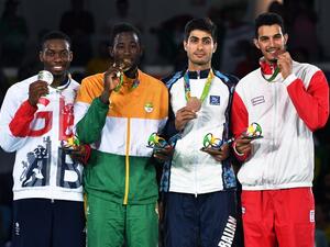 (L-R) Silver medalist Great Britain's Lutalo Muhammad, gold medalist Ivory Coast's Cheick Sallah Junior Cisse and bronze medalists Azerbaijan's Milad Beigi Harchegani and Tunisia's Oussama Oueslati pose with their medals on the podium after the men's taekwondo event in the -80kg category as part of the Rio 2016 Olympic Games, on August 19, 2016, at the Carioca Arena 3, in Rio de Janeiro.
Ed JONES / AFP