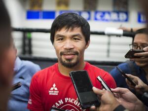 Filipino boxer Manny Pacquiao speaks with the media before his workout at the Wild Card Boxing Club in Hollywood, California, March 30, 2016. Pacquiao is in final preparation for his 12-round welterweight championship fight against Timothy Bradley, Jr. on April 9, 2016 in Las Vegas, Nevada. Veteran trainer Freddie Roach has vowed to back Pacquiao if the boxer decides to take advantage of rule changes which could see professional fighters allowed to take part in this summer's Olympics.
ROBYN BECK / AFP