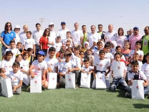 HRH Prince Ali poses for a group photo during the opening of a new artificial football pitch in the Zaatari Refugee Camp on Tuesday (Photo: PepsiCo)