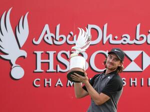 Tommy Fleetwood of England poses with the winner's trophy during the final day of the Abu Dhabi Golf Championship in the capital of the United Arab Emirates on January 22, 2017.
KARIM SAHIB / AFP
