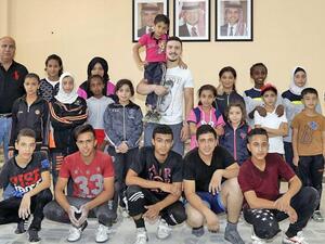 Nineteen-year-old Waleed Abu Nada (middle) poses for a group photo with the refugees participating in the Champ Camp programme in Al Baqaa camp recently (Photo: Waleed Abu Nada)