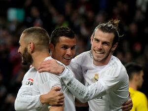 Real Madrid's Welsh forward Gareth Bale (R), Real Madrid's French forward Karim Benzema (L) and Real Madrid's Portuguese forward Cristiano Ronaldo (C) celebrate scoring during the Spanish league football match Real Madrid CF vs Sevilla FC at the Santiago Bernabeu stadium in Madrid on March 20, 2016.
PEDRO ARMESTRE / AFP