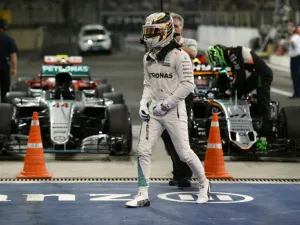 Mercedes AMG Petronas F1 Team's British driver Lewis Hamilton leaves his car after taking pole position in the qualifying session as part of the Abu Dhabi Formula One Grand Prix at the Yas Marina circuit on November 26, 2016. MOHAMMED AL-SHAIKH / AFP