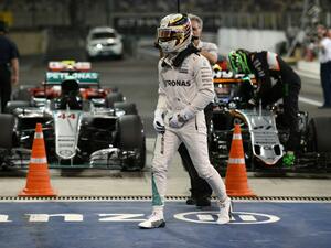 Mercedes AMG Petronas F1 Team's British driver Lewis Hamilton leaves his car after taking pole position in the qualifying session as part of the Abu Dhabi Formula One Grand Prix at the Yas Marina circuit on November 26, 2016. MOHAMMED AL-SHAIKH / AFP