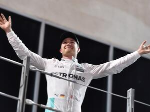 Mercedes AMG Petronas F1 Team's German driver Nico Rosberg celebrates at the end of the Abu Dhabi Formula One Grand Prix at the Yas Marina circuit on November 27, 2016. Nico Rosberg won his maiden F1 world title by securing second place behind his Mercedes arch-rival Lewis Hamilton. Andrej ISAKOVIC / AFP