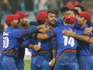 Afghan cricketer Rashid Khan (C), captain Asghar Afghan (R) celebrates with teammate after Match tied during the one day international (ODI) Asia Cup cricket match between Afghanistan and India at the Dubai International Cricket Stadium in Dubai on September 25, 2018.
ISHARA S. KODIKARA / AFP