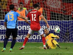 Wydad's goalkeeper Zouheir Laaroubi (R) vies for the ball with Ahly's forward Walid Azaro (C) during the CAF Champions League final football match between Al-Ahly vs Wydad Casablanca at the Borg El Arab Stadium in Alexandria on October 28, 2017.
STRINGER / AFP