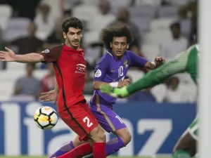 Al Rayyan's Mohamed Alaaeldin (L) vies for the ball against Al Ain's Omar Abdulrahman (R) during the AFC Champions League Round 2 Group (D) match Al-Ain (UAE) vs Al- Rayyan (Qatar) at Hazza Bin Zayed Stadium on February 20, 2018 in the UAE.
NEZAR BALOUT / AFP