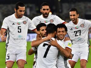 Al-Jazira's Emirati forward Ali Mabkhout (C, front) embraces his teammates Moroccan Mbark Boussoufa (C-L, behind) and Brazillian Romarinho (C-R, behind), as they celebrate after him scoring a goal against Urawa Reds during their FIFA Club World Cup quarter-final match at Zayed Sports City Stadium in the Emirati capital Abu Dhabi on December 9, 2017.
GIUSEPPE CACACE / AFP