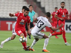 UAE's Al-Jazira club player Mohammad Al-Musalami (C) and Iran's Perspolis FC club player Siamak Nemati (L) vie for the ball during their AFC Champions League football match at the Mohammed Bin Zayaed Stadium in Abu Dhabi on May 7, 2018.
KARIM SAHIB / AFP