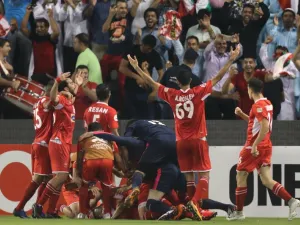 Persepolis FC's Ali Alipour (unseen) celebrates with teammates after scoring during the AFC Champions League semi-final first leg match between Al-Sadd SC FC and Persepolis FC at the Jassim Bin Hamad Stadium in Doha on October 2, 2018.
KARIM JAAFAR / AFP