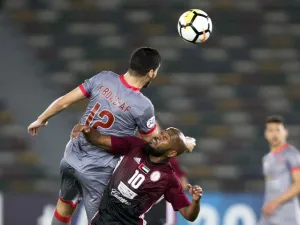 Al-Duhail's Karim Boudiaf (L) vies for the ball against al-Wahda's Ismaeil Matar during their AFC Champions League round 2 group stage football match at the Zayed Sports City Stadium in Abu Dhabi on February 19, 2018.
NEZAR BALOUT / AFP