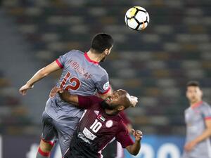 Al-Duhail's Karim Boudiaf (L) vies for the ball against al-Wahda's Ismaeil Matar during their AFC Champions League round 2 group stage football match at the Zayed Sports City Stadium in Abu Dhabi on February 19, 2018.
NEZAR BALOUT / AFP