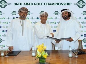 Oman Golf Committee Chairman Mundhir Al Barwani, centre, exchanges the documents with Mohammed Juma Buamaim, vice-chairman and CEO of ‘golf in DUBAi’. (Photo: Times of Oman) 