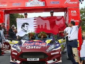 Qatari rally driver Nasser Salih Nasser Abdullah al-Attiyah (R) and French co-driver Matthiew Baumel pose for a photograph after finishing first at Iran International Rally, south-central Iran, on September 15, 2017. (Photo: Press TV)