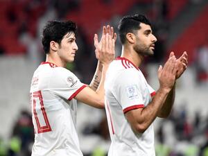 Iran's forward Sardar Azmoun (L) and Iran's midfielder Mehdi Taremi greets the fans following their victory during the 2019 AFC Asian Cup Round of 16 football match between Iran and Oman at the Mohammed Bin Zayed Stadium in Abu Dhabi on January 20, 2019.
Khaled DESOUKI / AFP