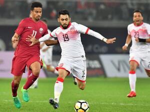 Qatar's Akram Afif (L) vies for the ball with Bahrain's Kamil al-Aswad (R) during the 2017 Gulf Cup of Nations football match between Qatar and Bahrain at the Sheikh Jaber al-Ahmad Stadium in Kuwait City on December 29, 2017.

GIUSEPPE CACACE / AFP