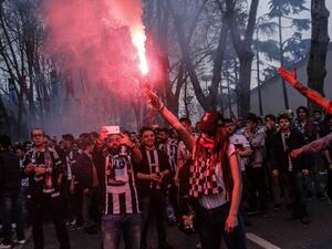 Besiktas supporters cheer their team before the Turkish Spor Toto Super league football match between Besiktas and Bursaspor at vodafone arena stadium on April 11, 2016 in Istanbul. Besiktas football team plays its first game at the new vodafone Arena stadium after its inauguration on April 10.
YASIN AKGUL / AFP