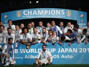 Real Madrid players pose with their trophy after winning the Club World Cup football final match against Kashima Antlers of Japan at Yokohama International stadium in Yokohama on December 18, 2016.
Behrouz MEHRI / AFP