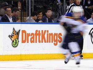 The New York Rangers and St. Louis Blues skate in front of a dasher board advertising the betting website DraftKings at Madison Square Garden on November 12, 2015 in New York City. Bruce Bennett/Getty Images/AFP
BRUCE BENNETT / GETTY IMAGES NORTH AMERICA / AFP