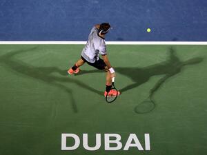 Roger Federer of Switzerland returns the ball to France's Benoit Paire during their ATP tennis match as part of the Dubai Duty Free Championships on February 27, 2017.

MAHMOUD KHALED / AFP