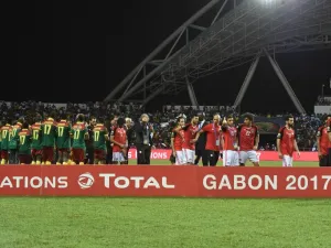 The Egyptian football team walks off the pitch as the Cameroon team wait to receive the winner's trophy after beating Egypt 2-1 in the 2017 Africa Cup of Nations final football match between Egypt and Cameroon at the Stade de l'Amitie Sino-Gabonaise in Libreville on February 5, 2017.
ISSOUF SANOGO / AFP